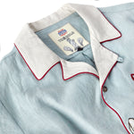 close up of inside shirt label with Billion Oyster Project and Tombolo logos