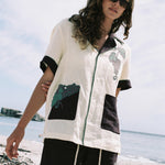 Female model wearing full 'Tombarolo' Cabana set on the beach with sunglasses on