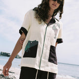 Female model wearing full 'Tombarolo' Cabana set on the beach with sunglasses on