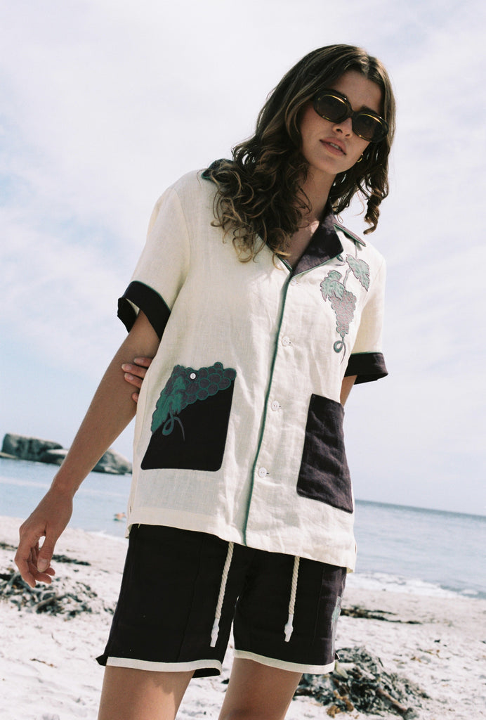 Female model wearing full 'Tombarolo' Cabana set on the beach with sunglasses on