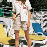 woman with eyes closed poses on the beach