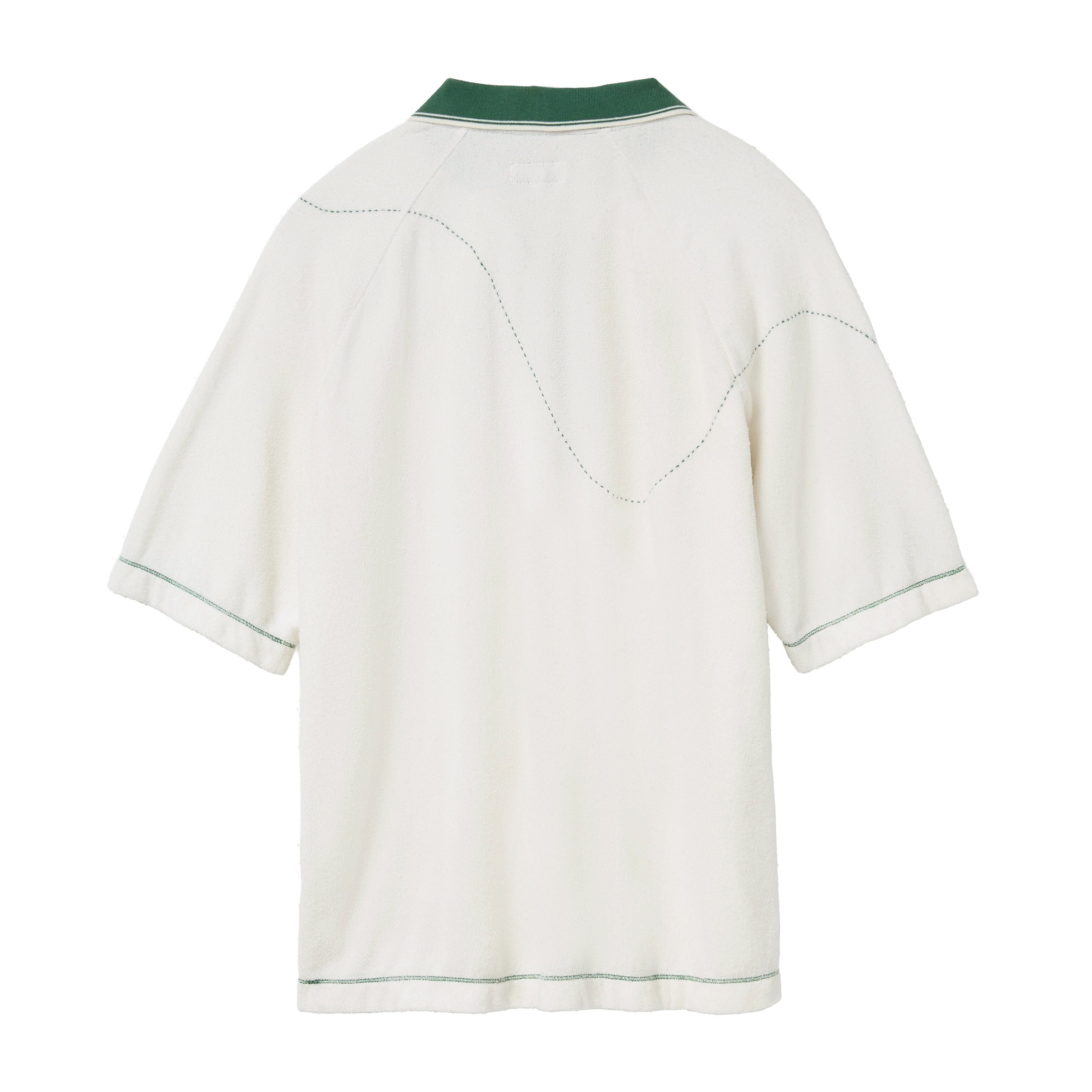 Back of a white terry cloth polo shirt with a green collar and green contrast stitching. A curved dotted line is embroidered across the upper back and sleeves, evoking the motion of a golf ball in flight.