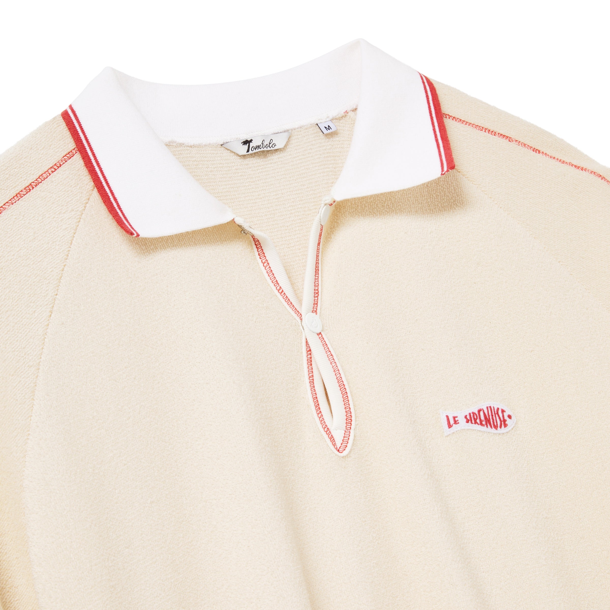 Beige polo shirt with white collar and red accents on a white background