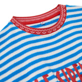 Close-up of a blue and white striped garment with red trim and text.