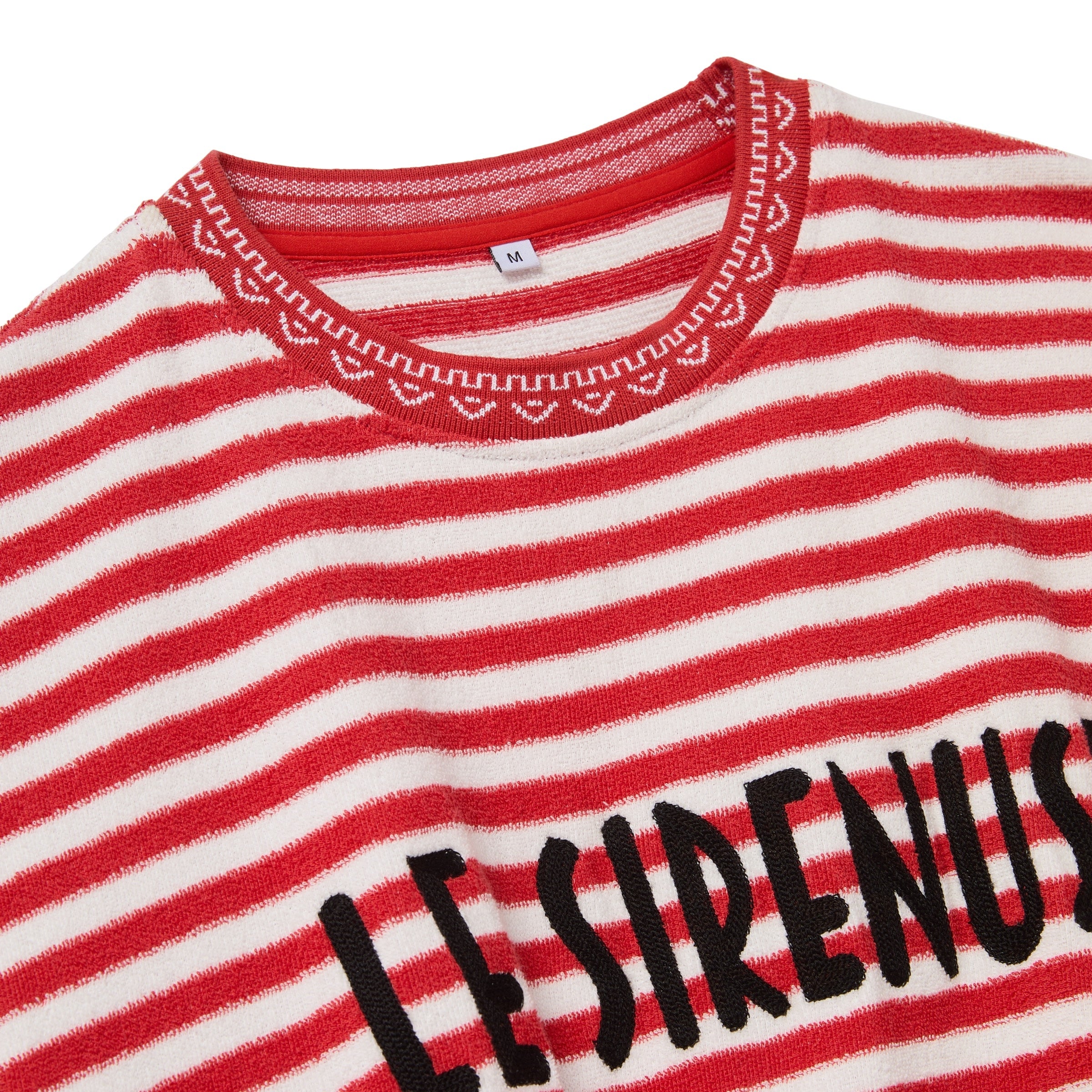 Close-up of Red and white striped shirt with 'LE SIRENUSE' text on a white background