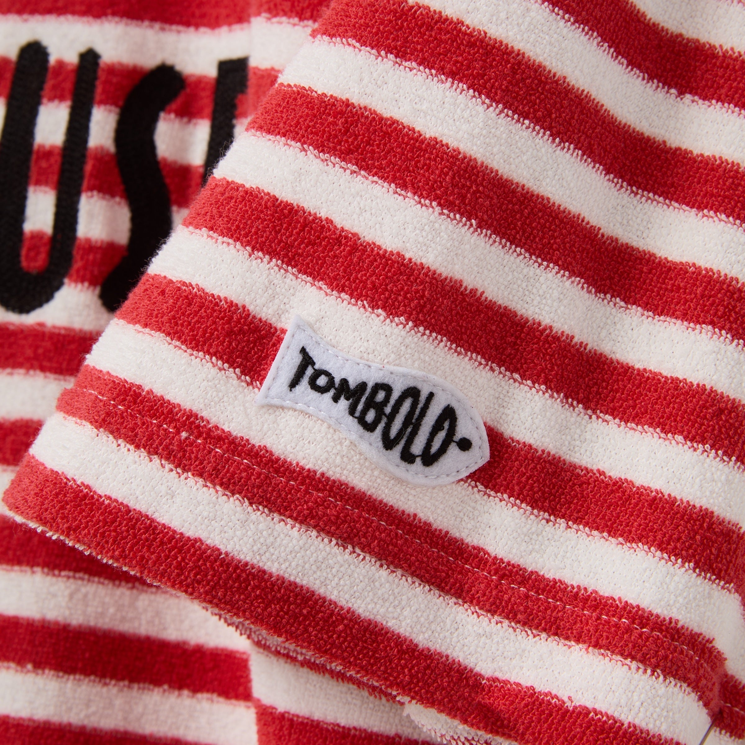 Red and white striped fabric with a 'Tombolo' label.