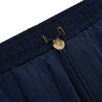 Navy blue shorts with a gold clasp on a white background