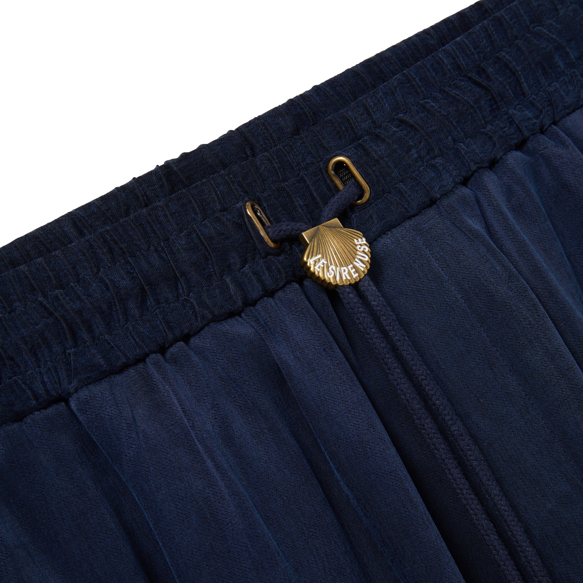 Navy blue shorts with a gold clasp on a white background