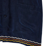 Navy blue shirt with a pocket and colorful stripe at the hem on a white background