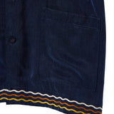 Navy blue shirt with a pocket and colorful stripe at the hem on a white background
