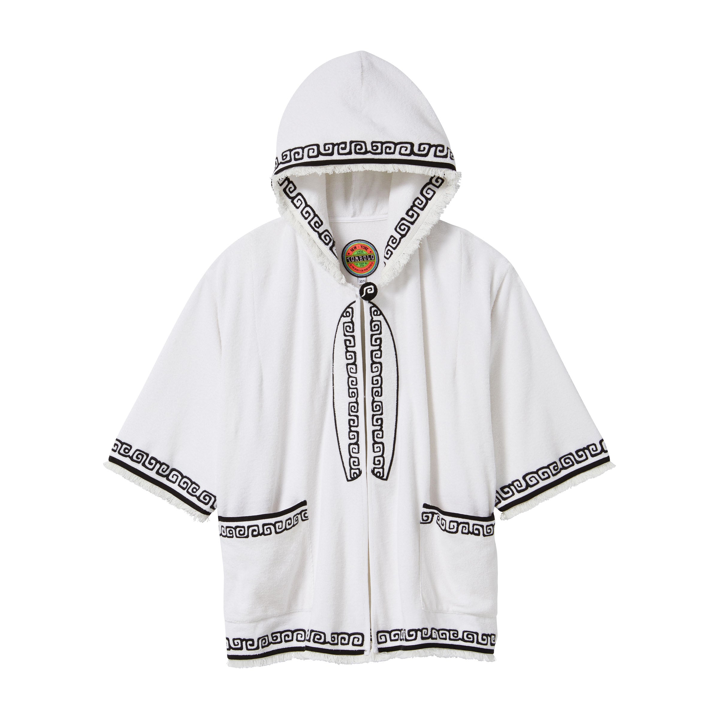 White short-sleeve terry cloth hooded beach towel top with black embroidered trim, black embroidered surf board, two pockets, and frayed edges. 