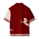 Back of red cabana shirt with mermaid swimming around the side.