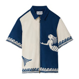 Blue and white zip-up shirt with mermaid design on a white background