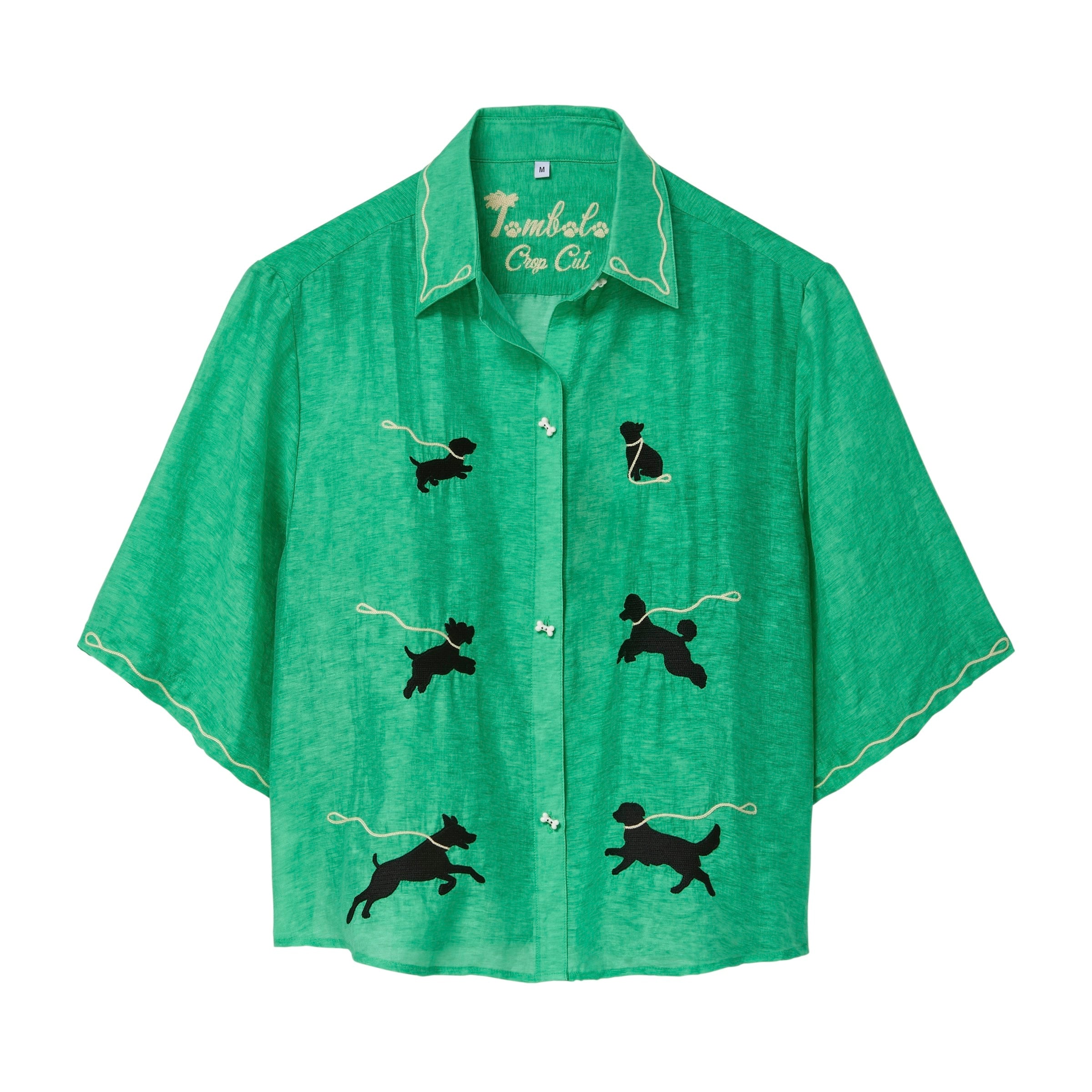 Green cropped cabana shirt with black dog silhouettes across the front, each attached to a white leash motif, with white piping along the collar and sleeves.