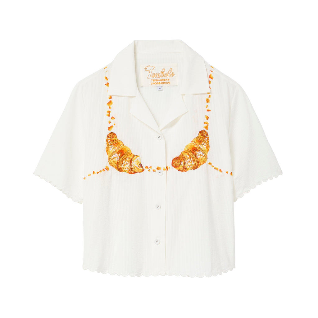 White shirt with croissant design on a white background.