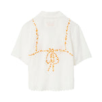 Back of white seersucker shirt, with embroidered bikini ties across the back. 