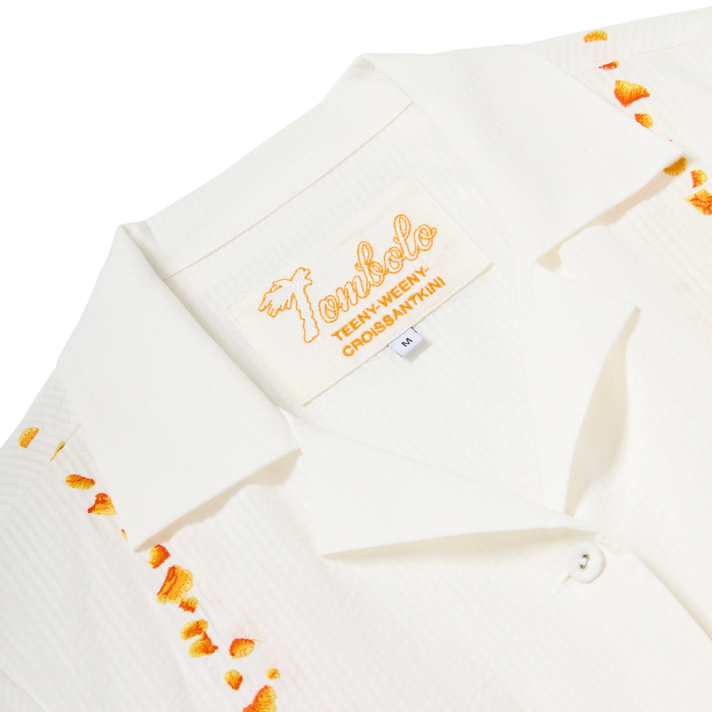 Close-up of interior label for 'Teeny-weeny-croissantkini'.