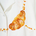 Close-up image of the embroidered croissant. 