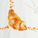 Close-up image of the embroidered croissant. 