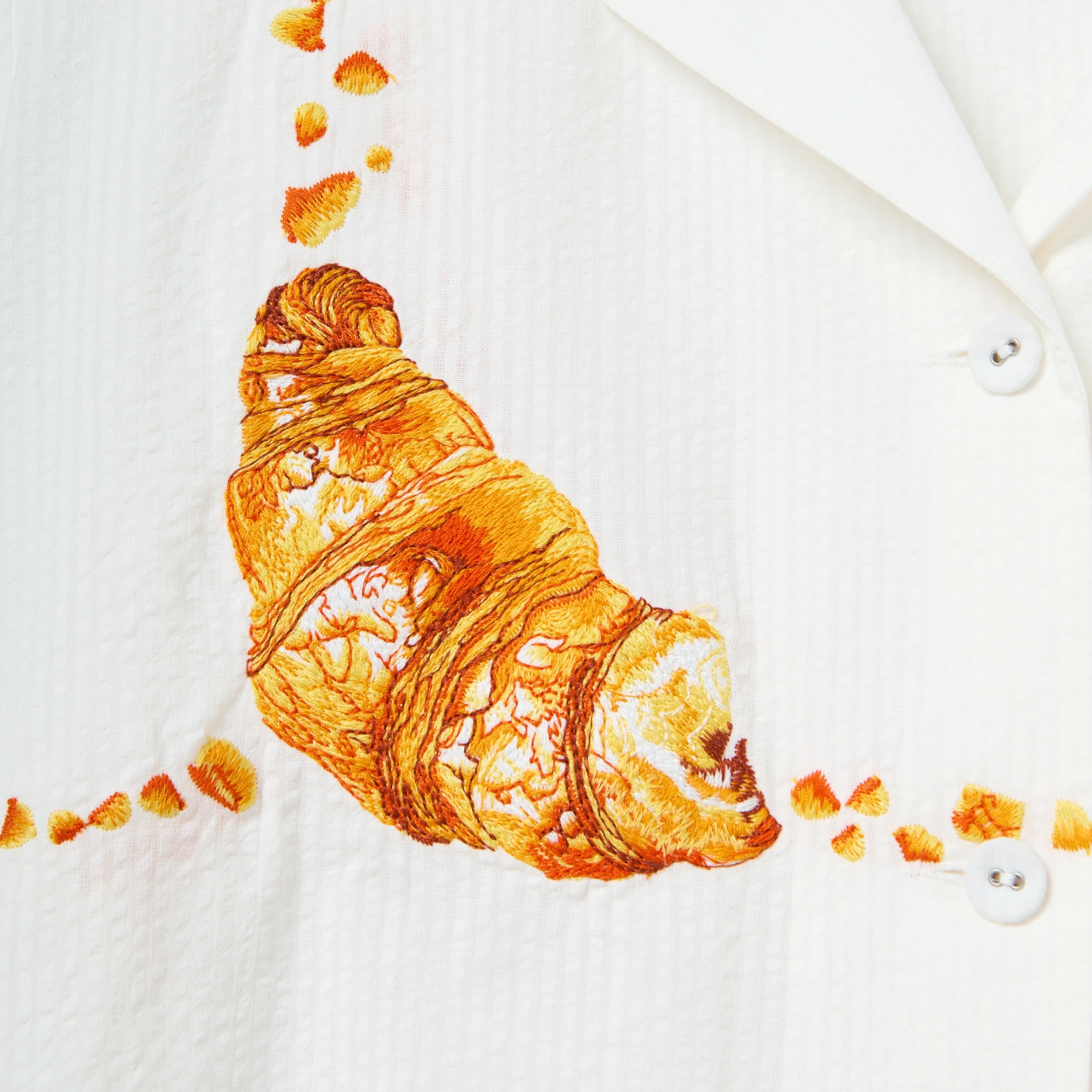Close-up image of the embroidered croissant. 