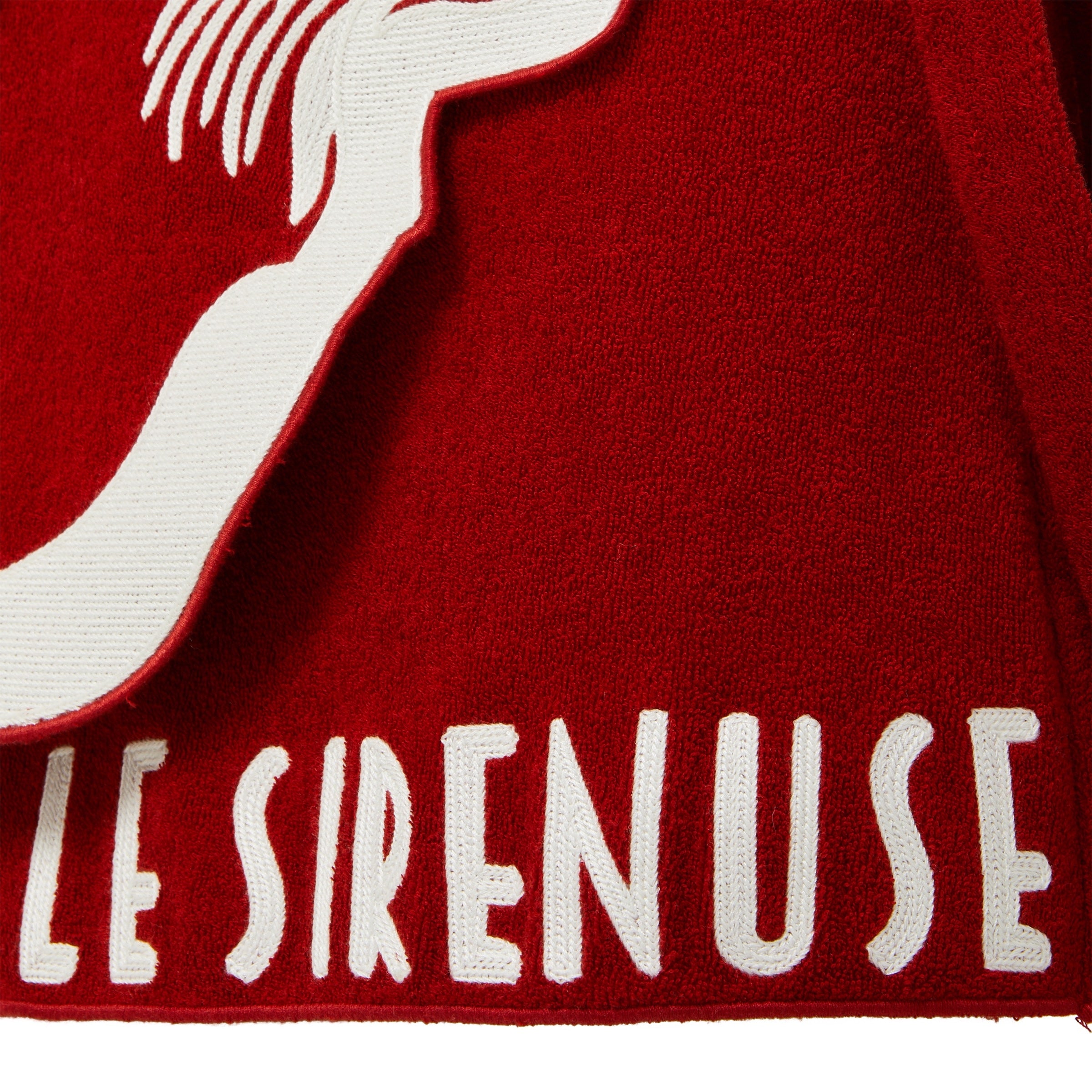 Red skirt with white embroidered design and text 'LE SIRENUSE'.