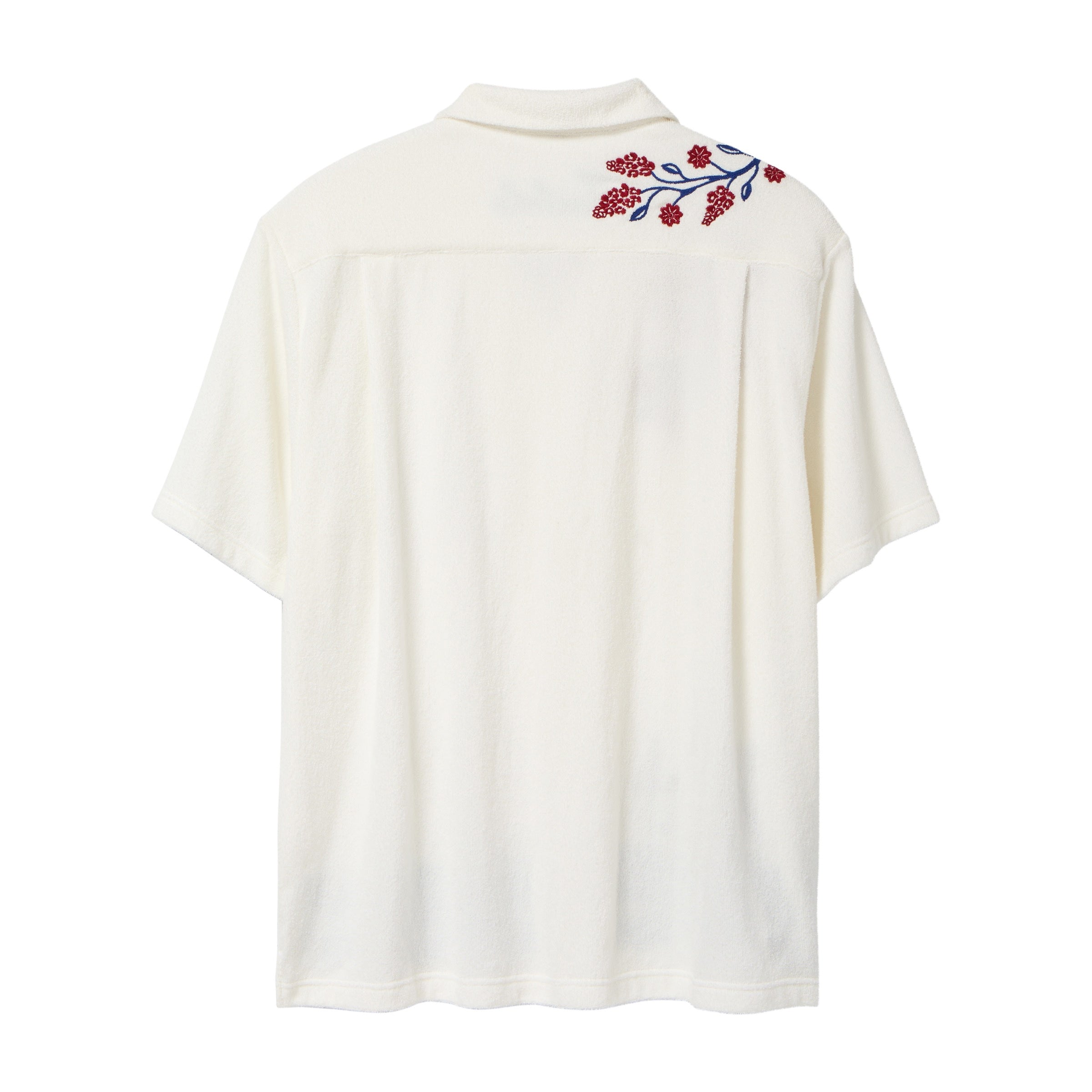 Back view of a cream terry cabana shirt with embroidered red floral vines and blue leaves on the shoulder.