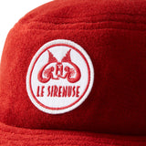 Close-up of Le Sirenuse patch on red terry cloth bucket hat.