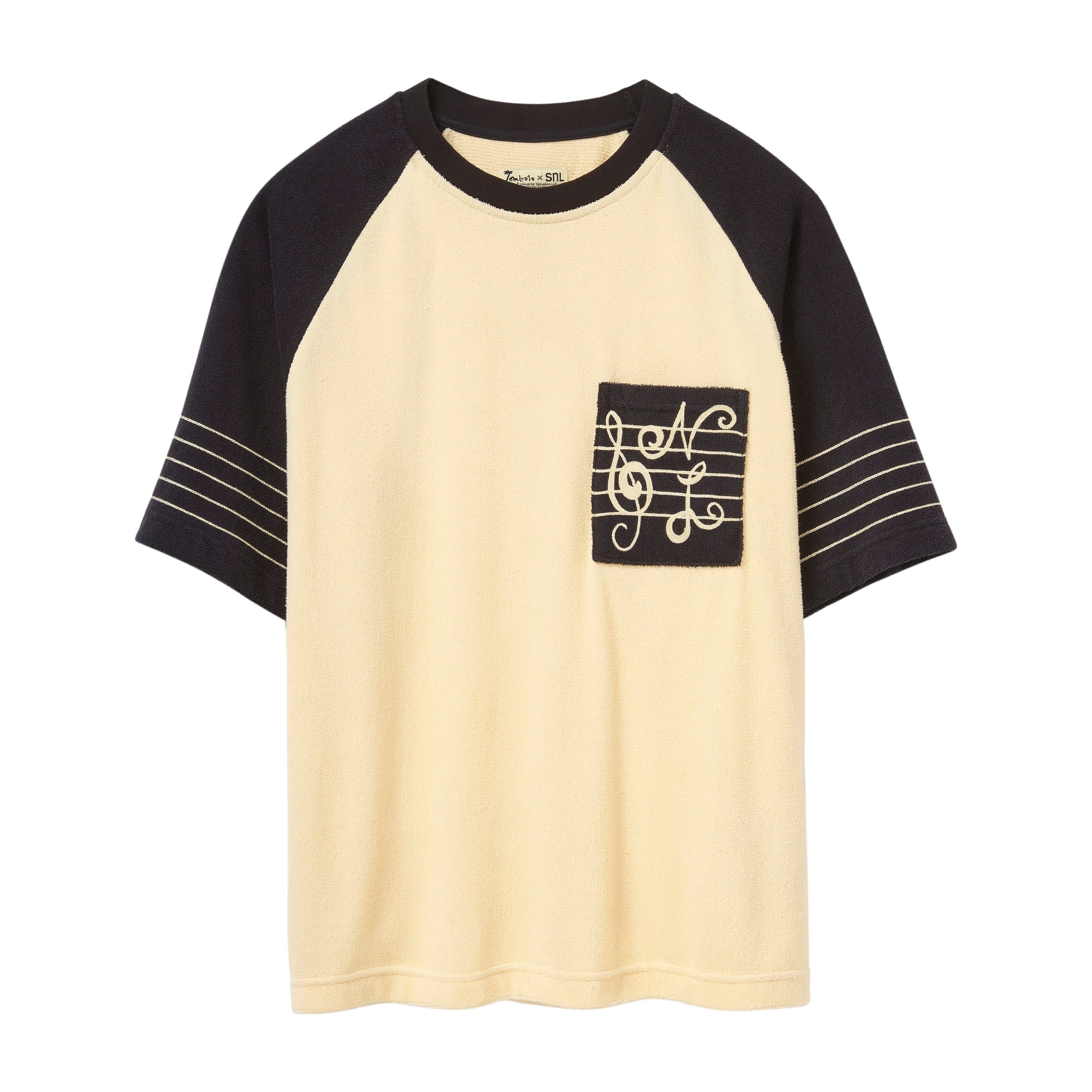 Short-sleeve raglan terry shirt with cream body, black sleeves, and SNL-embroidered chest pocket.