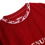 Close-up of a red shirt with white embroidery on a white background