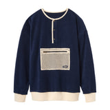 Navy blue pullover with a beige pocket on a white background