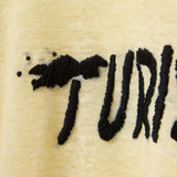 Close-up detail shot of the Turismo embroidery.