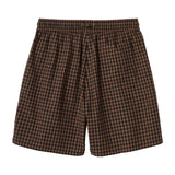 Brown and black checkered shorts on a white background