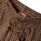 Brown plaid shorts with a Tombolo label on a white background