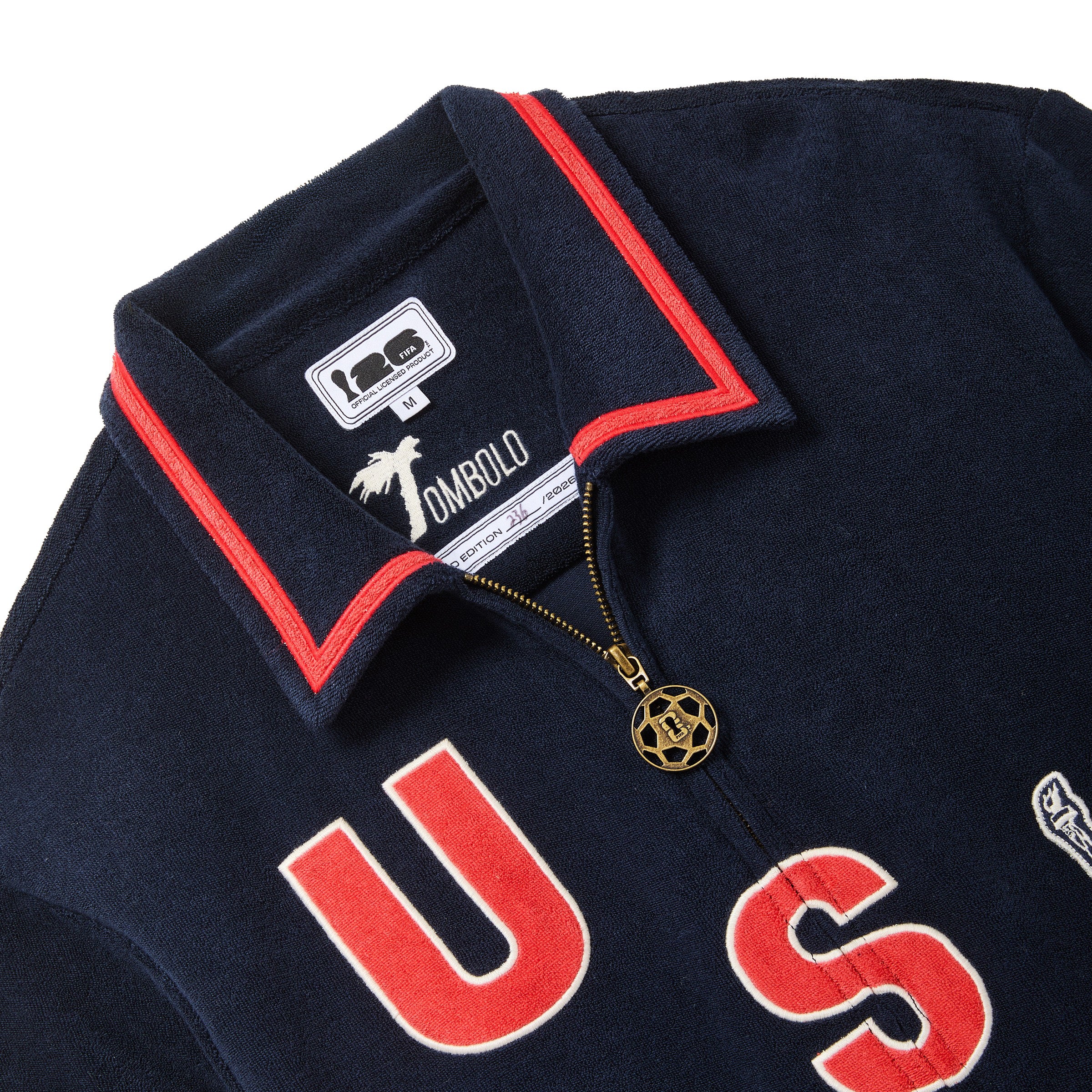 Navy blue polo shirt with red accents and 'U.S.' branding, featuring an interior limited edition label.