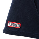 Navy blue terrycloth sleeve with a red and white 'Tombolo' logo patch.