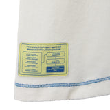 Close-up of a white shirt with a yellow label detailing FIFA World Cup 2026 matches at New Jersey Stadium.