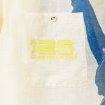 Close-up of a beige pocket with yellow text and logo on a garment, featuring 'FIFA New York New Jersey'.