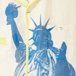Close-up of statue of liberty graphic on front chest of shirt. 