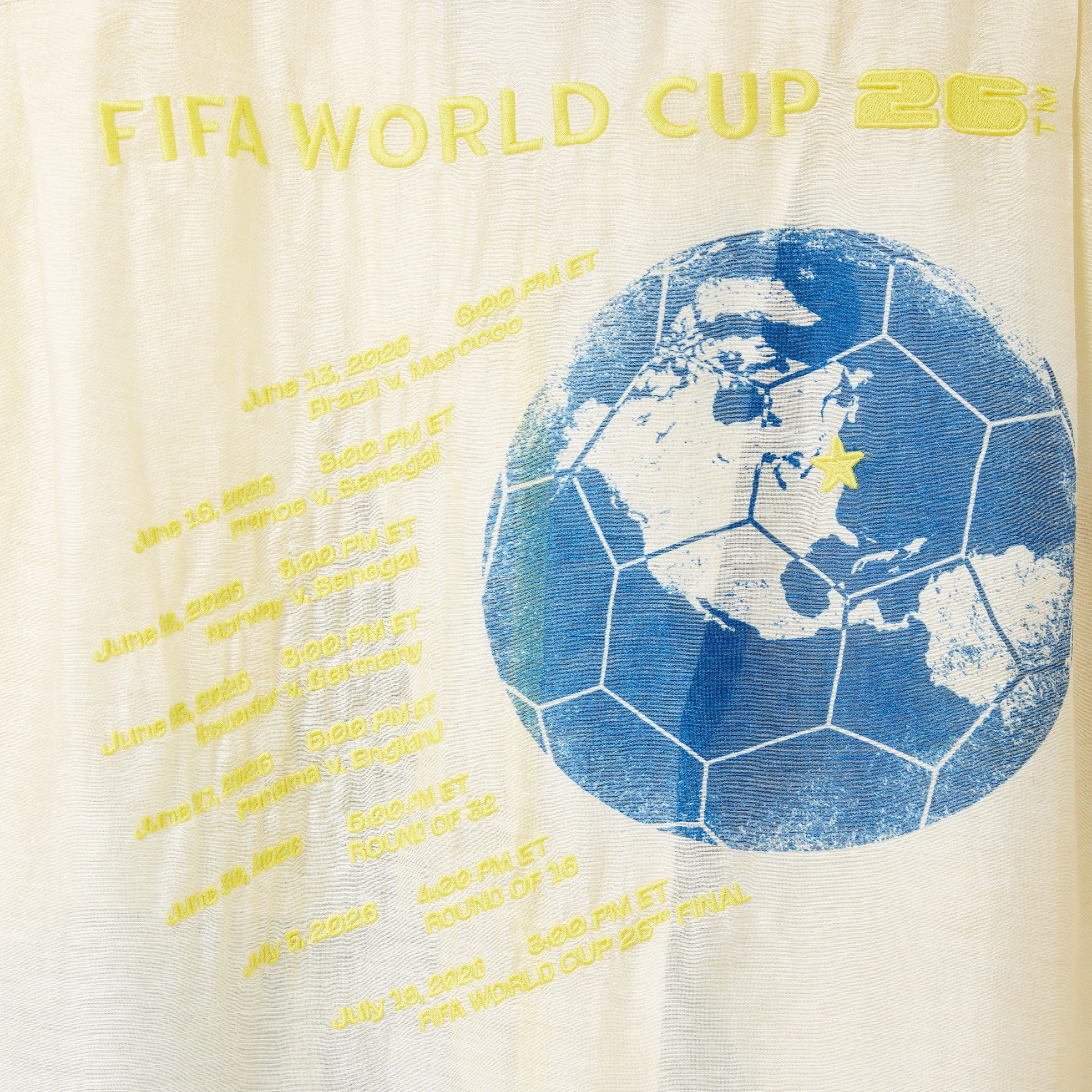 Back of Lady Liberty Shirt: FIFA World Cup 2026 logo with a stylized world map on a beige background