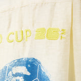 Text 'CUP 26' embroidered on beige fabric. 