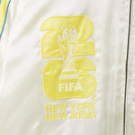 Embroidered FIFA logo on a white jacket with 'New York New Jersey' text.