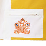 Embroidered Sunset Beach logo on a white pocket with yellow trim