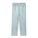 back of blue linen Tombolo pants with elastic waistband and Signature v-shaped Tombolo pocket on the right side