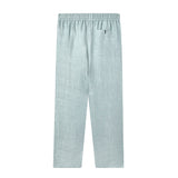back of blue linen Tombolo pants with elastic waistband and Signature v-shaped Tombolo pocket on the right side