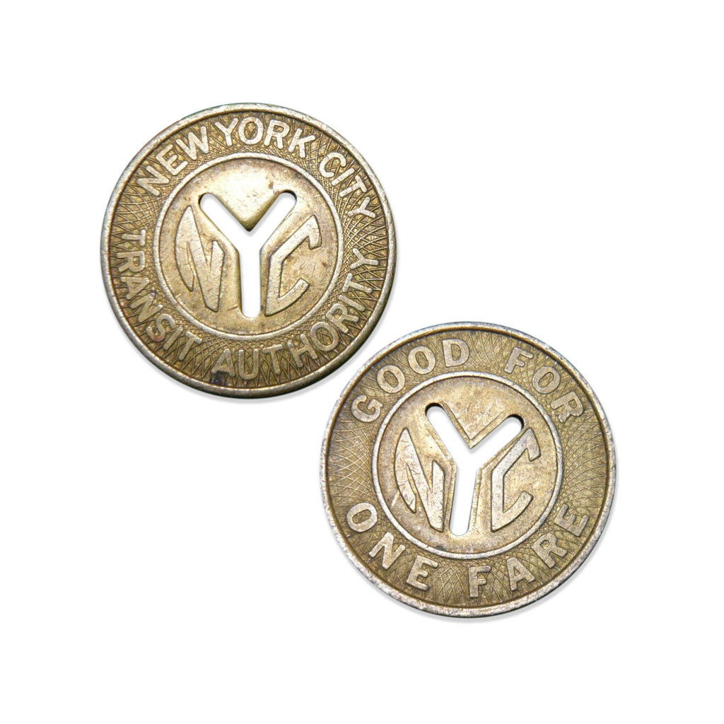 Close ups of subway tokens saying New York City Transit Authority and Good for one fare