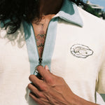 Close up of man holding zipper down wearing oyster terry cloth shirt