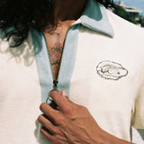 Close up of man holding zipper down wearing oyster terry cloth shirt