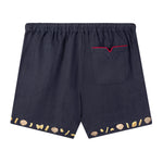 Back view of Tombolo linen shorts with signature V pocket and red piping