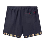 Back view of Tombolo linen shorts with signature V pocket and red piping