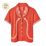 Short-sleeve terry cloth shirt in bright orange with white embroidered lobsters on the collar and coiled telephone cord detailing along the front and sleeves. Small sticker that reads "Crop Cut"